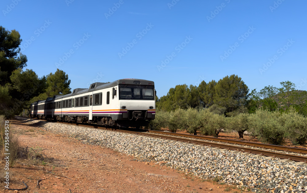 Train on railway. Spain regional commuter train in motion on railway. Spanish National Rail Network. Passenger Travel by train in European countries. Train drive on Spain railway in Sagunt - Gilet Train on railway. Spain regional commuter train in motion on railway. Spanish National Rail Network. Passenger Travel by train in European countries. Train drive on Spain railway in Sagunt - Gilet