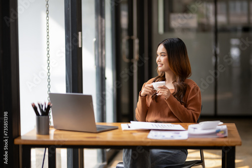 Freelance businesswoman enjoy with coffee in offece. photo