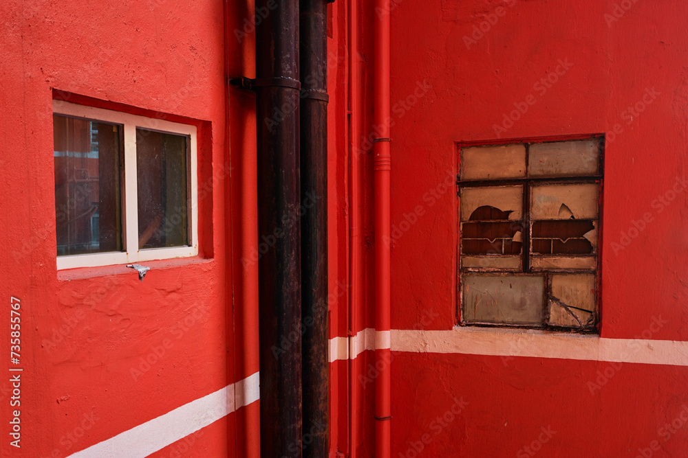Architecture of Hong Kong City. Wall of red painted condominium.