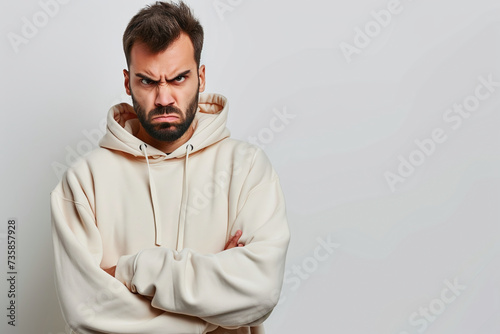 Young man with a dissatisfied face on a white background photo