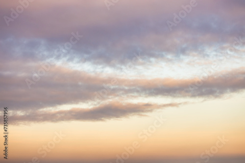 Fototapeta Naklejka Na Ścianę i Meble -  A beautiful sky tinted by the sun leaving vibrant shades of gold, pink, blue and multicolored. Clouds in the twilight evening and morning sky. Cloudy sky background in the evening and during the day.