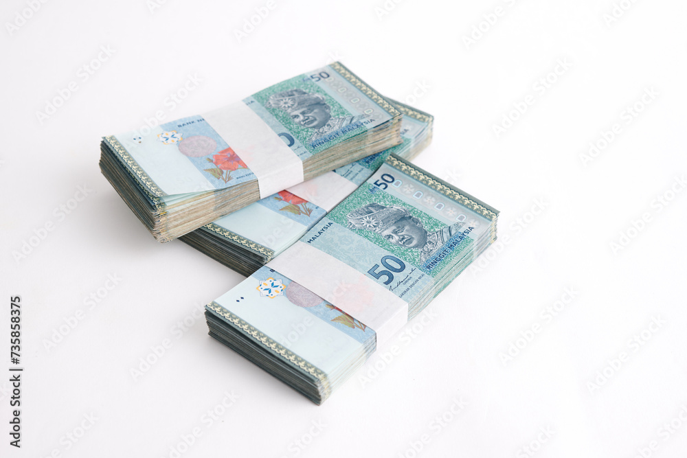 Stack of RM50 Ringgit Malaysia on white background. Selective focus. Stack of RM50 Ringgit Malaysia on white background. Selective focus.