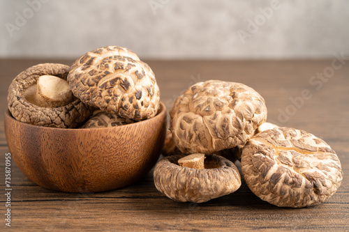 Dried shiitake mushroom in woodle bowl, healthy food. photo