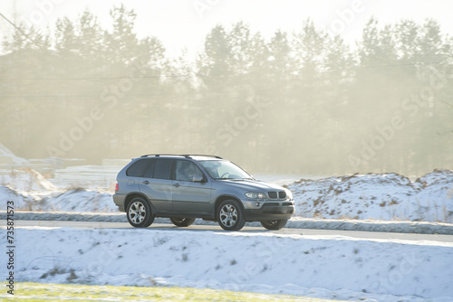 SUV Roams Snowy Path in Majestic Expedition. Conquering Winter Grip. Winter tires and a good car battery. © AlexGo