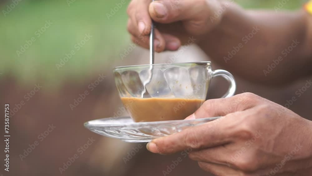 beautiful video of a cup of milk coffee being stirred in a white glass outdoors beautiful video of a cup of milk coffee being stirred in a white glass outdoors