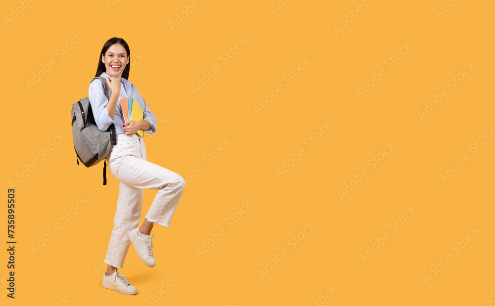 Joyful female student with backpack and copybooks smiling Joyful female student with backpack and copybooks smiling