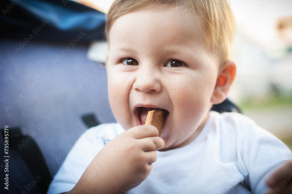 Portrait of happy and smilling cute baby boy eating his favorite child biscuit. Healthy nutrition for kids concept Portrait of happy and smilling cute baby boy eating his favorite child biscuit. Healthy nutrition for kids concept