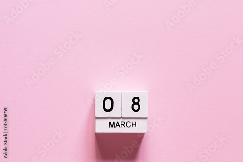 March 8 postcard. Wooden cubes number eight on a pink background. Happy Women's Day photo