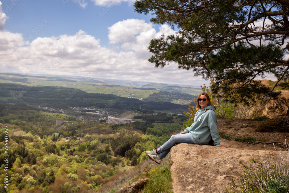 Woman on a mountain cliff