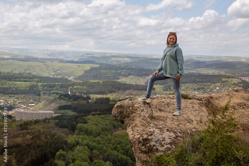 Woman on a mountain cliff