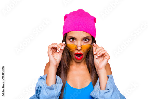 WOW! Close up portrait of shocked girl face looks over the glasses directly at the camera isolated on bright pink background
