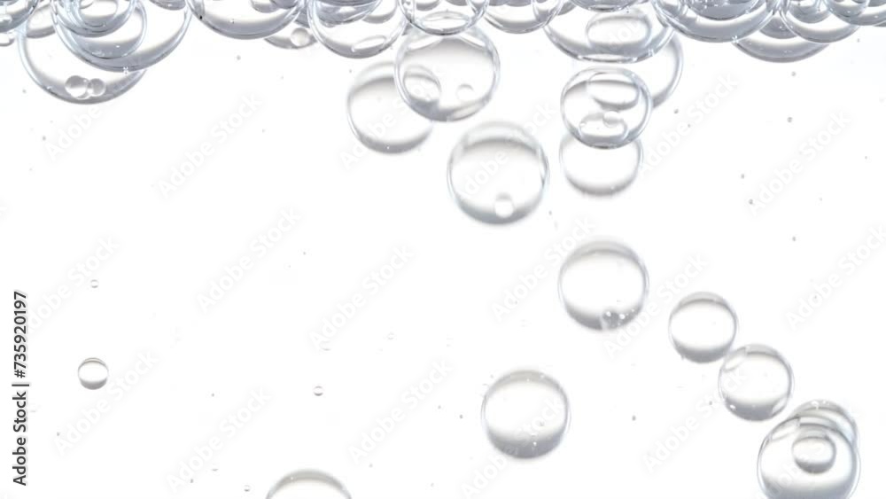 Macro Shot of Different Sized Clear Air Bubbles in Clear Water Rising up on White Background. Body Care Cosmetics Concept. Essence, Liquid Bubble, Molecule. Slow Motion . High quality FullHD footage Macro Shot of Different Sized Clear Air Bubbles in Clear Water Rising up on White Background. Body Care Cosmetics Concept. Essence, Liquid Bubble, Molecule. Slow Motion . High quality FullHD footage