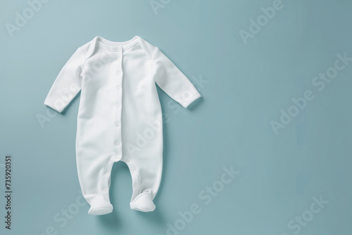 Mockup of white baby sleepsuit on pastel background. Blank baby clothes template, flat lay. photo