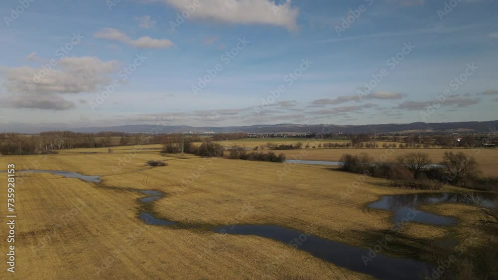 Aerial drone flying over autumn fields with swamps