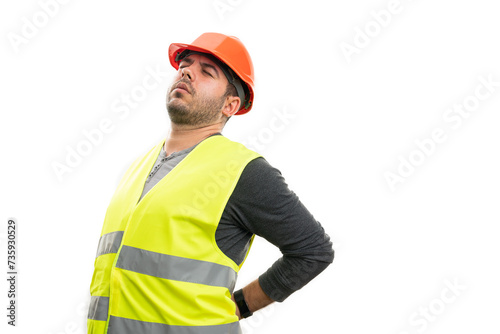 Man builder touching painful lower back wearing vest and hardhat