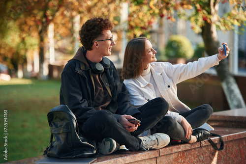 Taking a selfie. Two young students are together outdoors