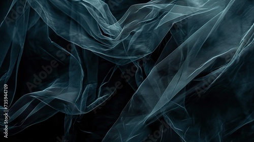 A dark and moody background with silken fabric undulating like shadows in water, ideal for sophisticated designs, fashion editorials, and artistic expressions, offering space for contemplative text.