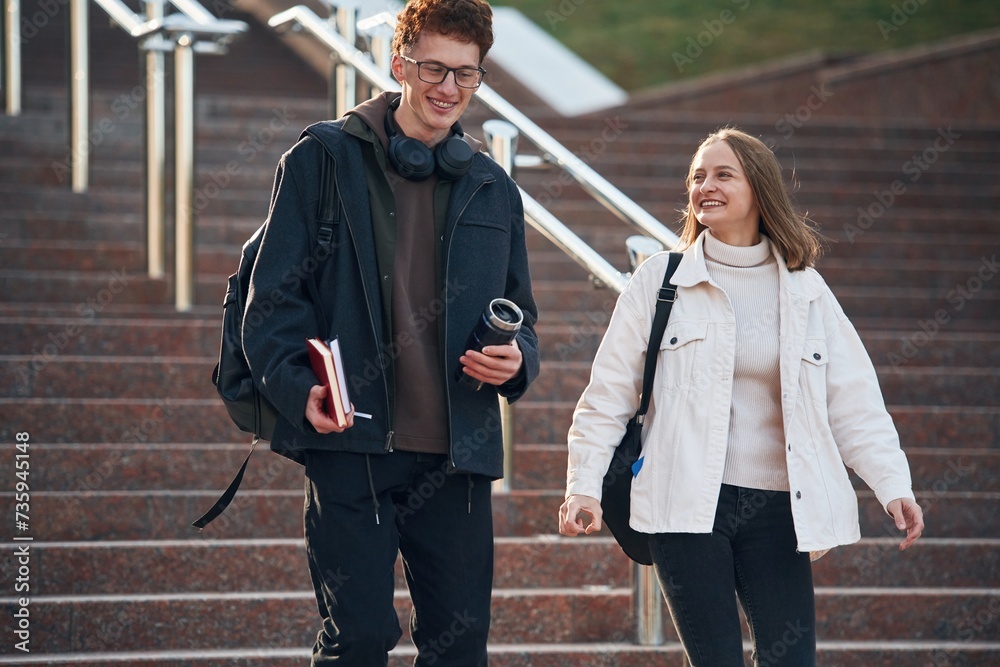 Obraz premium Having a break. Two young students are together outdoors