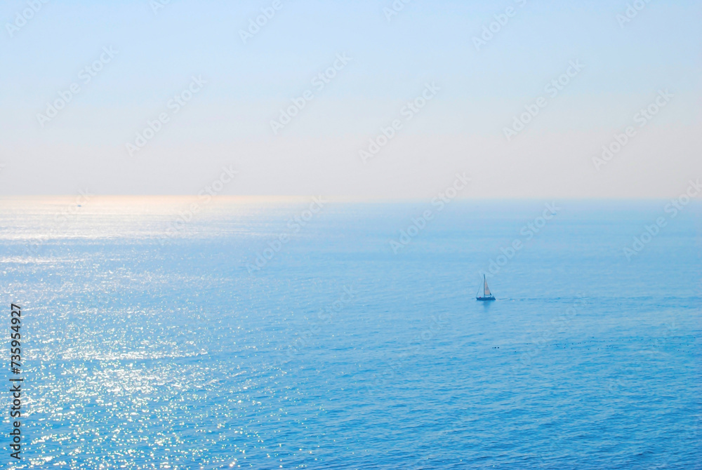 Serenity at Sea - A Lone Boat on the Calm Ocean at Sunrise