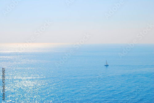 Serenity at Sea - A Lone Boat on the Calm Ocean at Sunrise