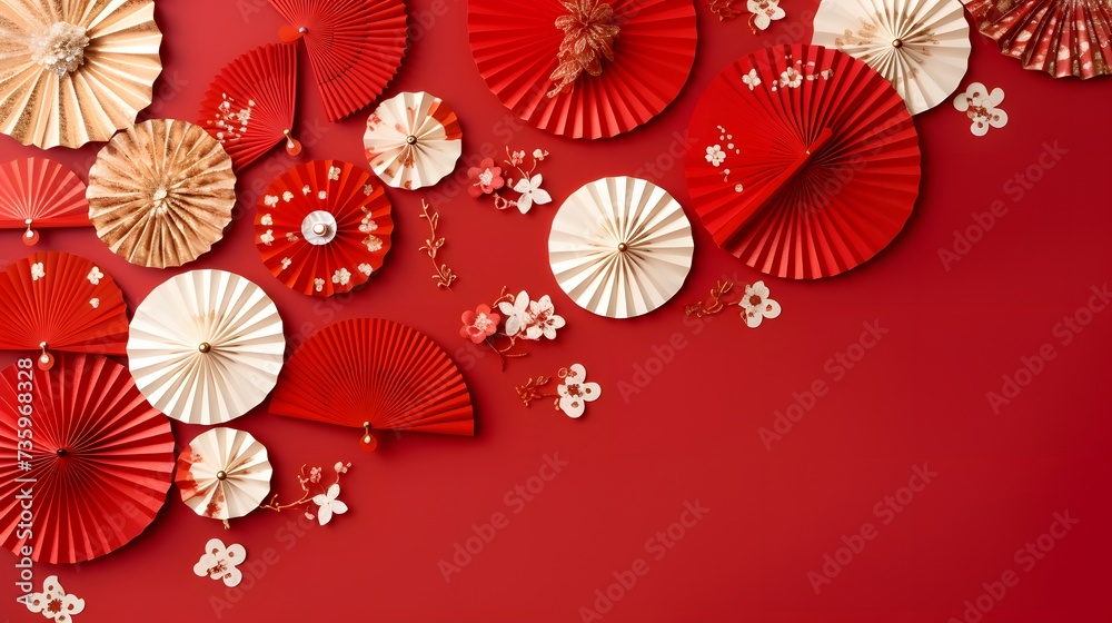 Chinese new year festival or wedding decoration over red background. Traditional lunar new year paper fans. Flat lay, top view, banner