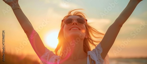Joyful young woman celebrating success with arms raised in the air