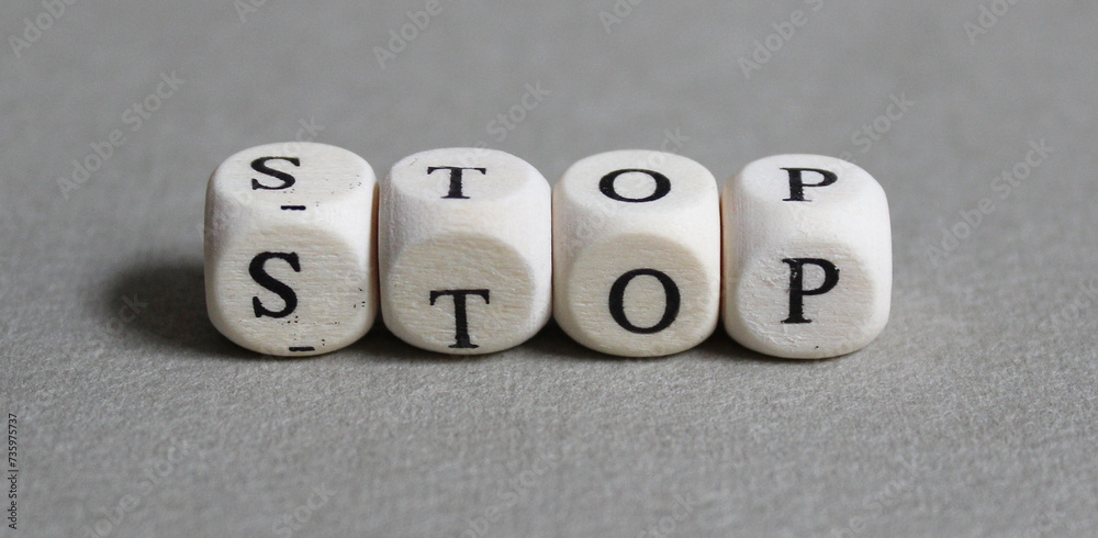 Wooden cubes form the word STOP. Wooden cubes form the word STOP.