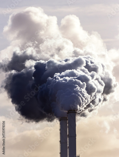 Smoking chimney pipes of a electro power station plant  causing air pollution.
