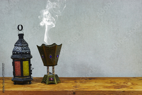 Fotografi arabic lantern and censer incense burner on wood table for ramadan and eid El fi