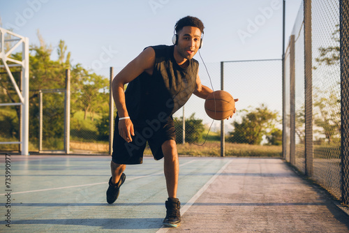 black man doing sports, playing basketball on sunrise, active lifestyle, sunny summer morning