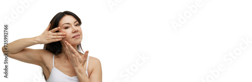 Wallpaper Mural Beautiful middle aged woman doing facial massage with hands against white studio background with negative space to insert text. Concept of beauty, antiaging procedure, self care, lifting, moisturizing Torontodigital.ca