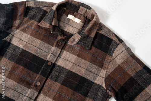 Checkered long sleeve brown shirt isolated on white background © Sondem