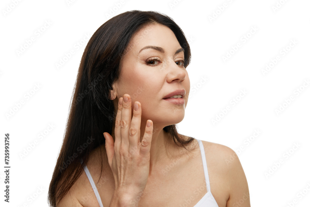 Middle aged brunette woman touching her face, skin after facial care therapy against white studio background. Effect after spa treatments. Concept of beauty, antiaging, lifting and moisturizing. Ad Middle aged brunette woman touching her face, skin after facial care therapy against white studio background. Effect after spa treatments. Concept of beauty, antiaging, lifting and moisturizing. Ad