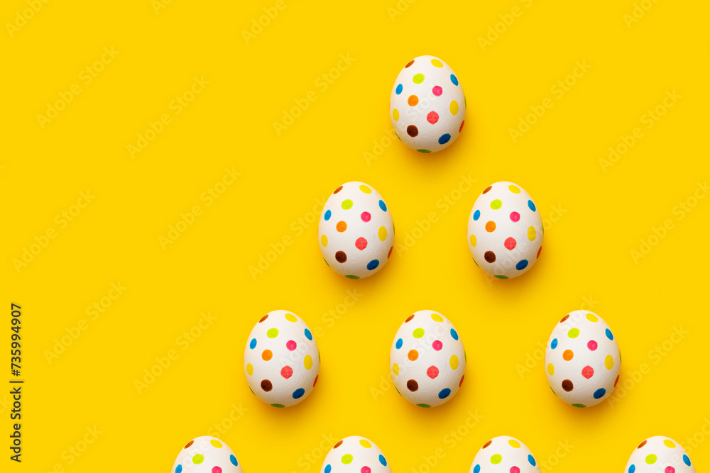 Spotty painted colorful easter eggs flat lay  on yellow background