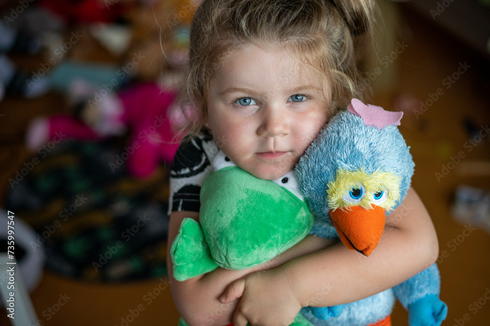 Young girl being shy hugging her teddies for comfort Young girl being shy hugging her teddies for comfort