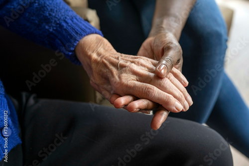 Helper caring for elderly lady photo
