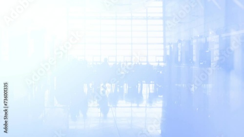 Background with moving people in a large room with glass walls. Exposure effect photo