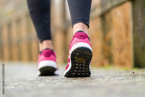 healthy fit woman listening to music in the park