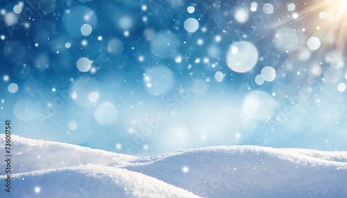 winter snow background with snowdrifts with beautiful light and snow flakes on the blue sky beautiful bokeh circles banner format copy space © Michelle