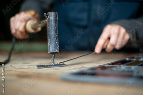 apprentice glass maker, stained glass craftman inspecting herwork
