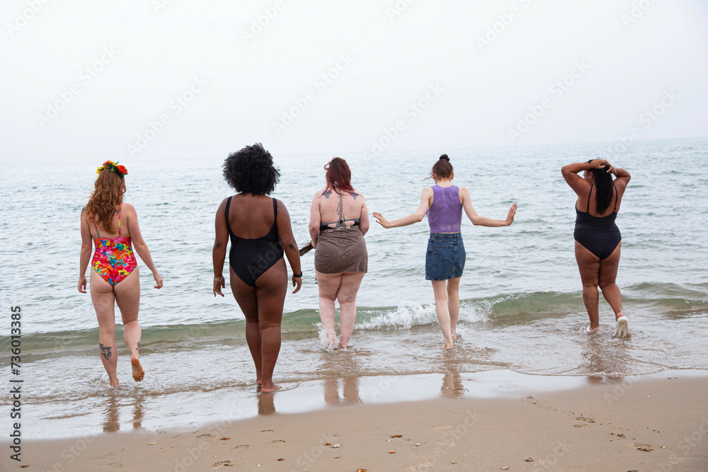 A mixed group of female friends having fun at the beach. A mixed group of female friends having fun at the beach.