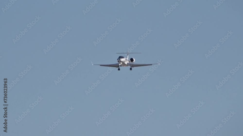 High end business jet flying final approach for landing at executive airport High end business jet flying final approach for landing at executive airport
