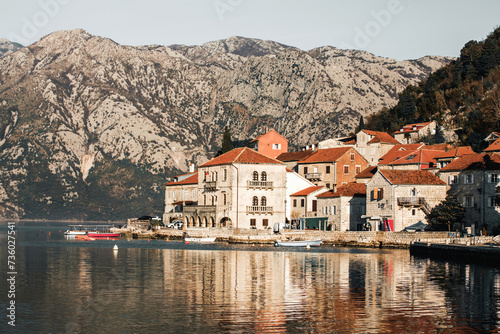 Perast. Panorama view of the historic town at famous Bay of Kotor with boats in early morning. Mountains at background. Perast, Boka Kotorska, Montenegro © Elena