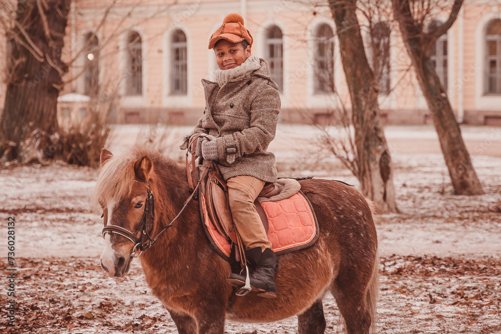 Naklejka premium Перейти к странице|123456Далее little rider smiling while riding a pony