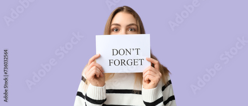 Young woman holding paper w...