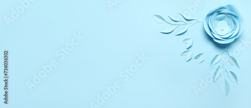 Beautiful paper flower and leaves on light blue background with space for text