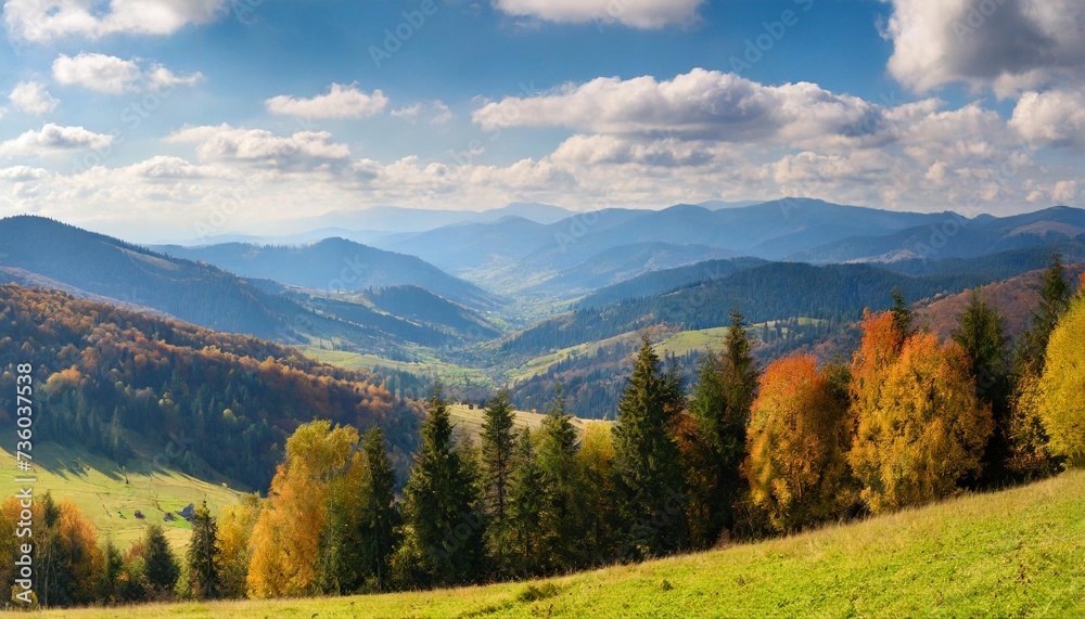 panorama of mountainous carpathian countryside in autumn forested hills rolling down in to the distant rural valley beautiful scenery on a sunny day with clouds on the sky
