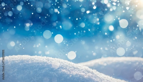 winter snow background with snowdrifts with beautiful light and snow flakes on the blue sky beautiful bokeh circles banner format copy space © Diann