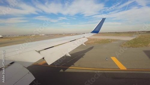 Airplane wing view taxiing at generic airport taxiway photo