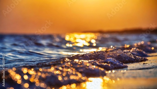 blurred texture background for design golden bokeh of sea waves at sunset summer vacation concept